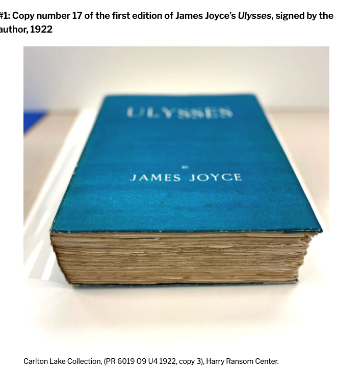 Copy number 17 of the 1922 first edition of Ulysses lying on its side, showing the blue cover and the browned edges of the pages.